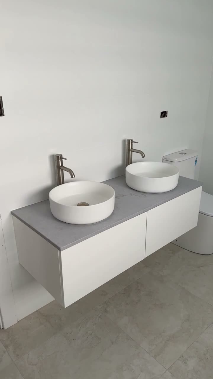 Double round vessel basins on a stone-top floating vanity